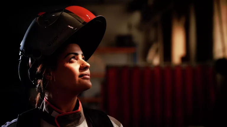 A welder with a Fronius Vizor 4000 helmet raised