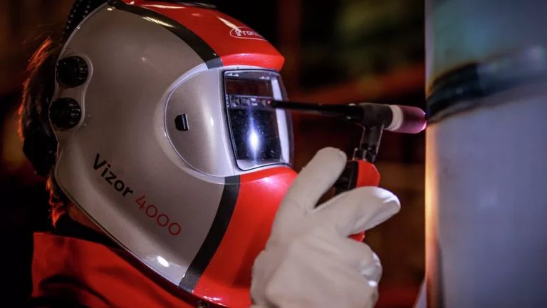 A welder in a Fronius Vizor 4000 helmet TIG welding a pipe
